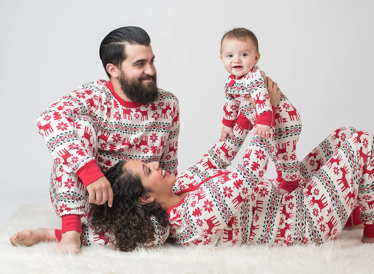 Family wearing matching holiday pajamas