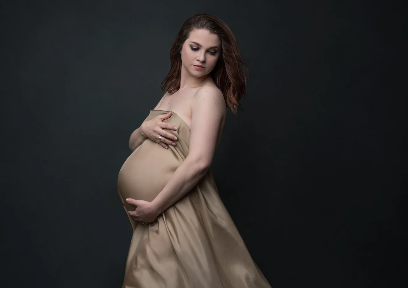 dramatic maternity portrait with wrapped fabric