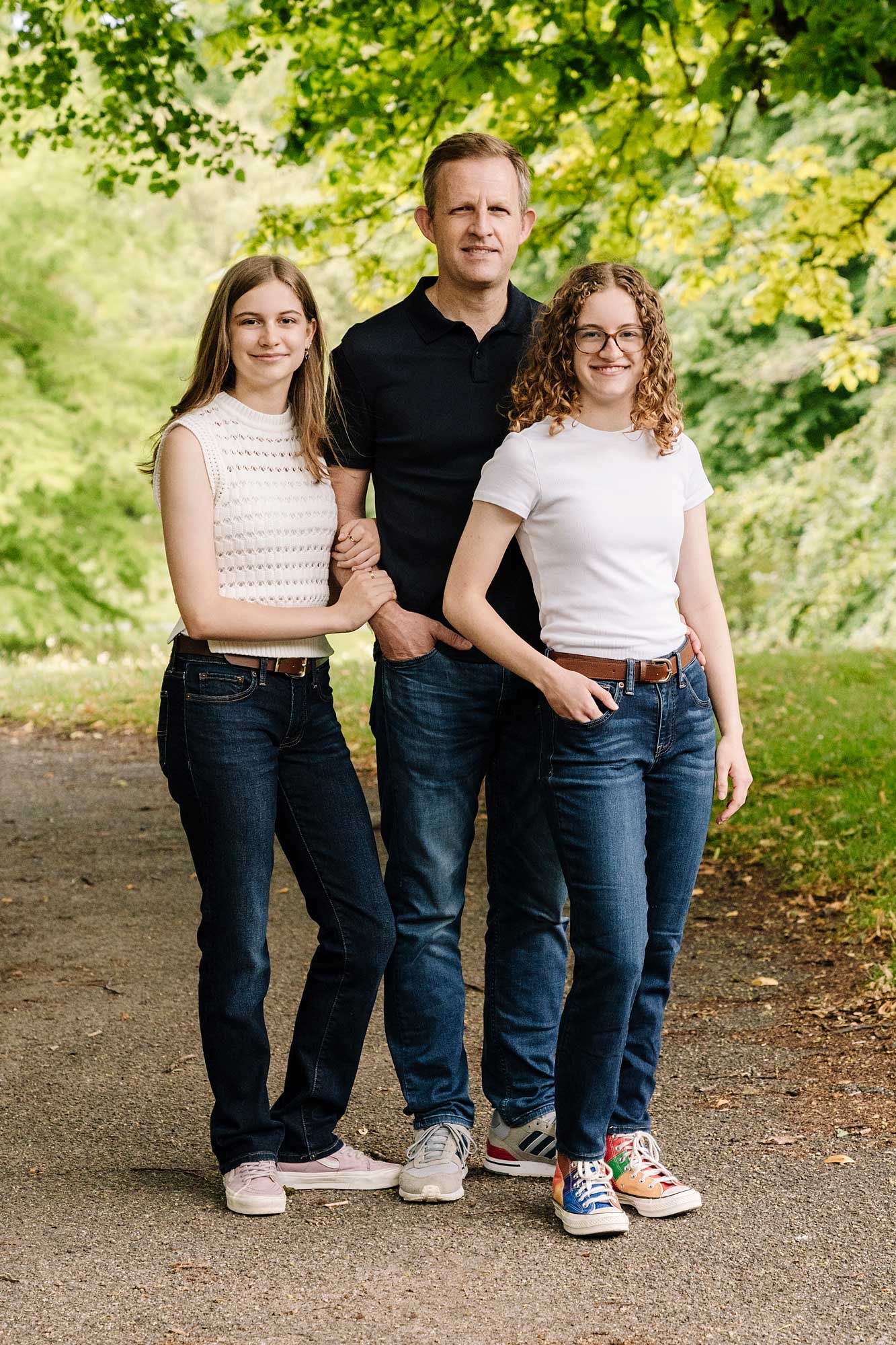 A father and his two daughters standing for a photo in the Netherlands. 