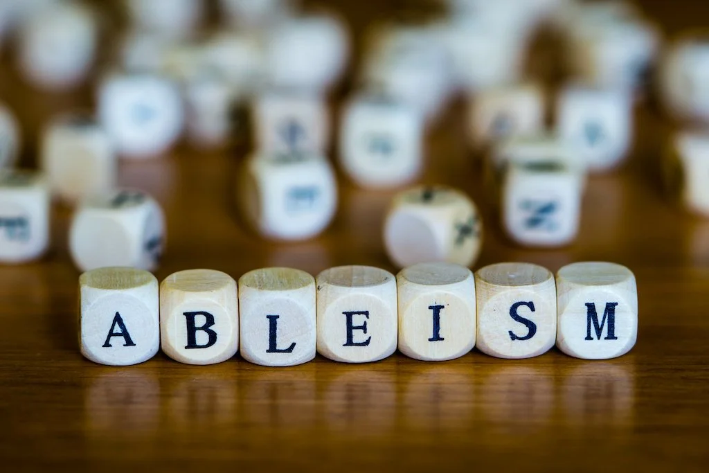 How does ableist language promote ableism?