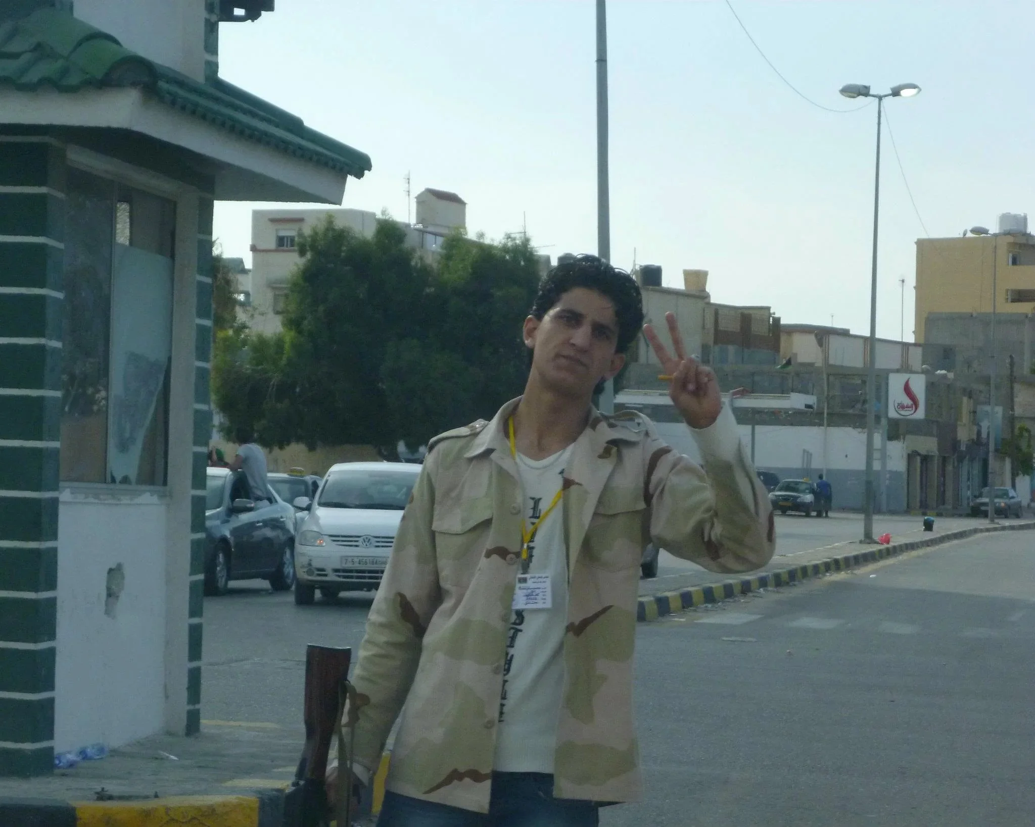 Young man making a victory sign — Tripoli, 20 October 2011