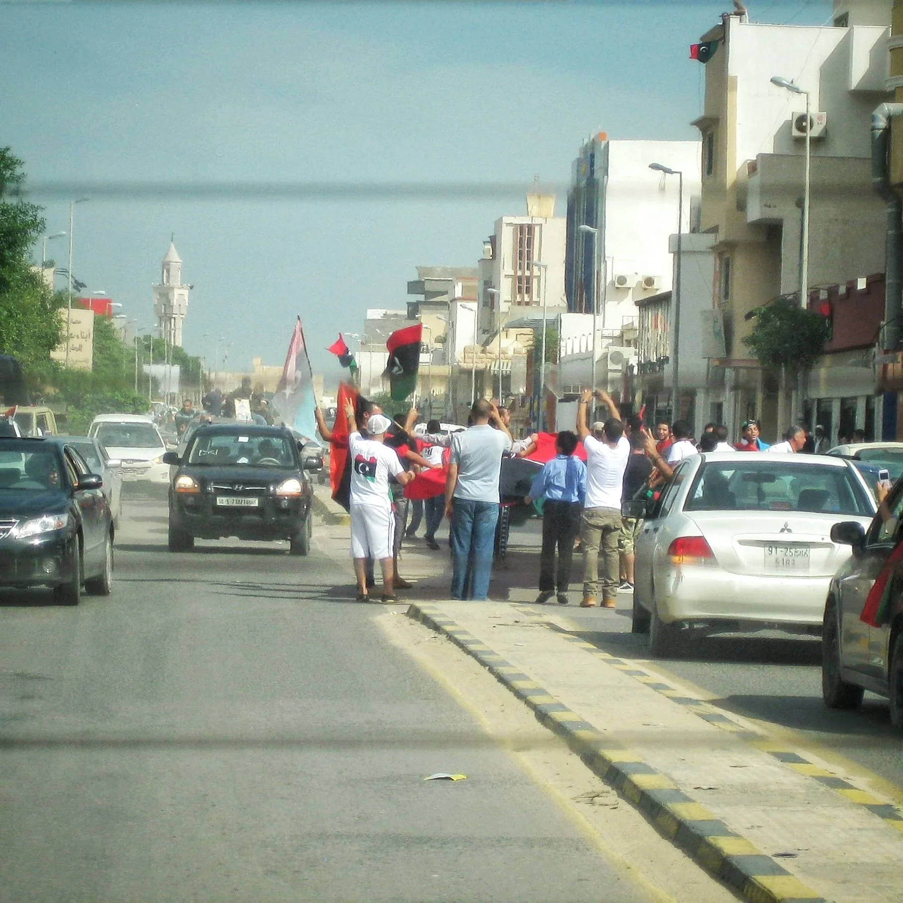 A street procession approaching the camera — Tripoli, 20 October 2011