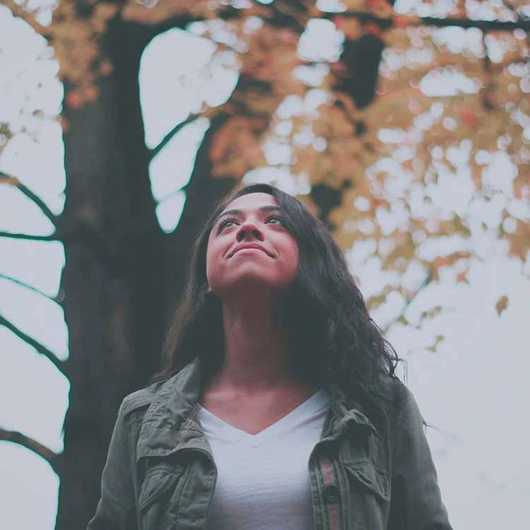 Adult woman outside looking hopeful after starting therapy