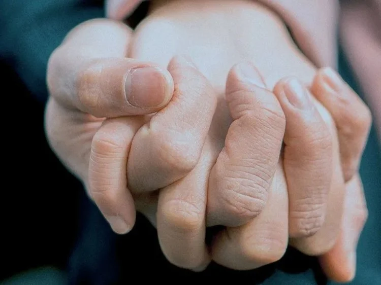 couple holding hands during therapy session