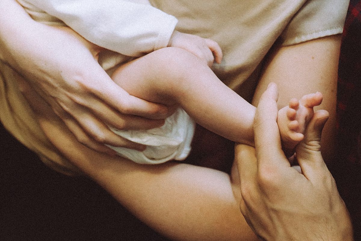 nyc family and newborn photographer close up of newborn baby girl feet in stairwell in Chelsea apartment block