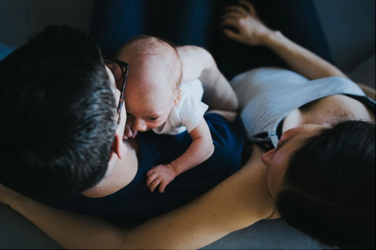nyc family and newborn photographer bird's eye view of mom, dad and newborn son