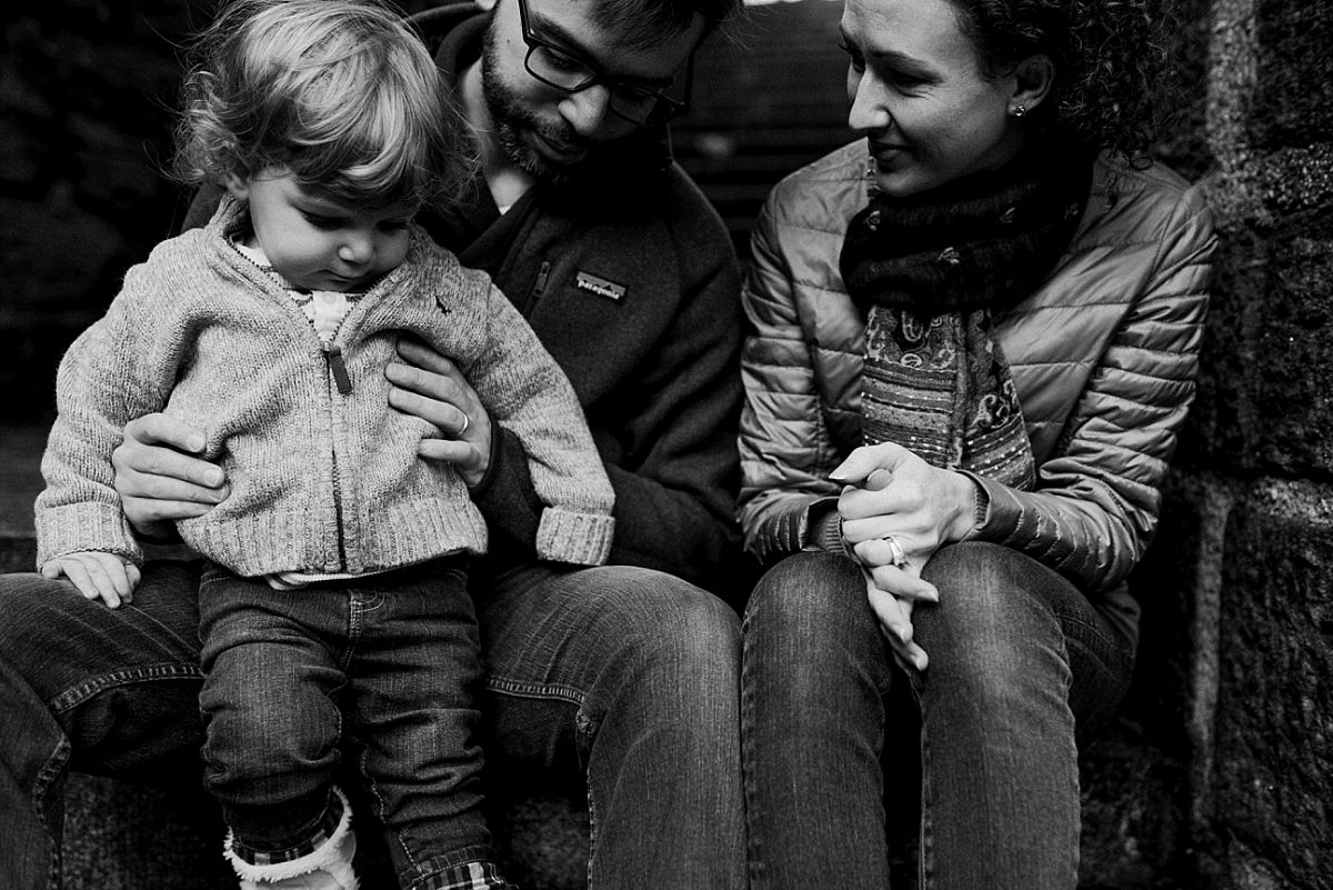 nyc family and newborn photographer mom, dad and toddler play on park steps in nyc's loveliest park