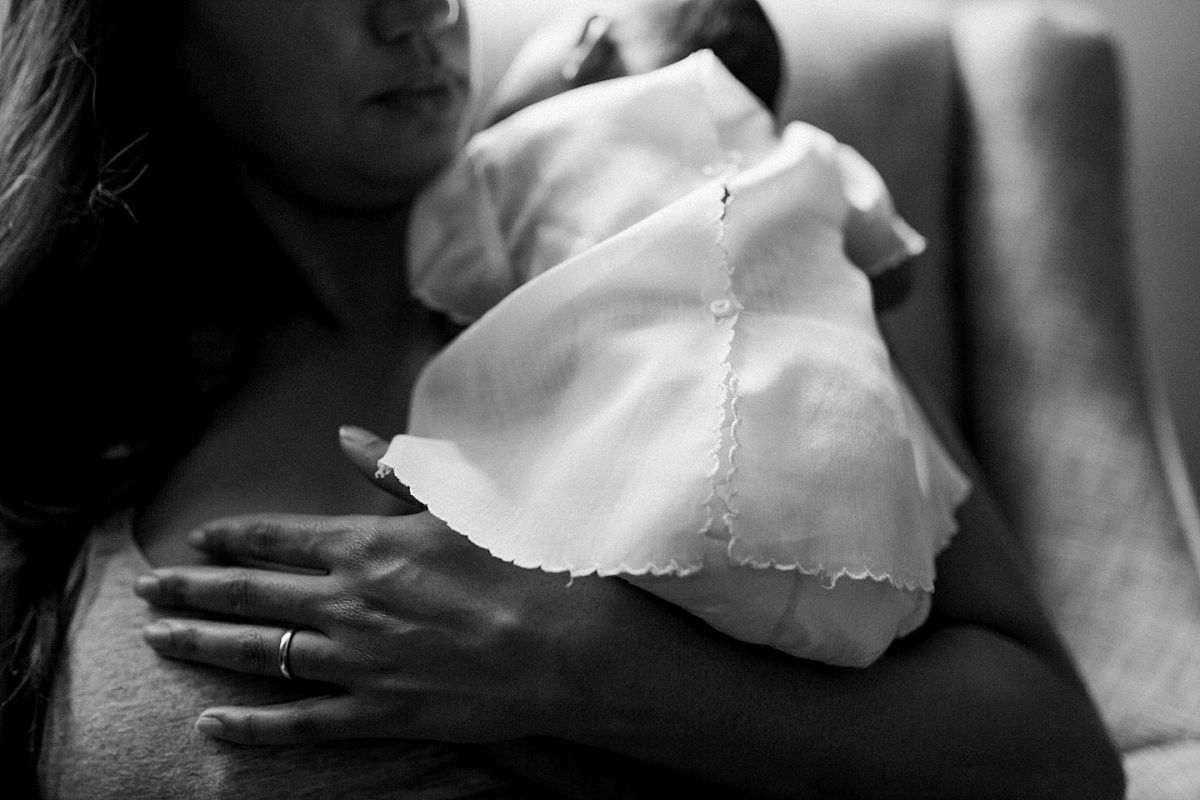 nyc family and newborn photographer newborn girl in white dress lies on mom's shoulder in mommy and me session