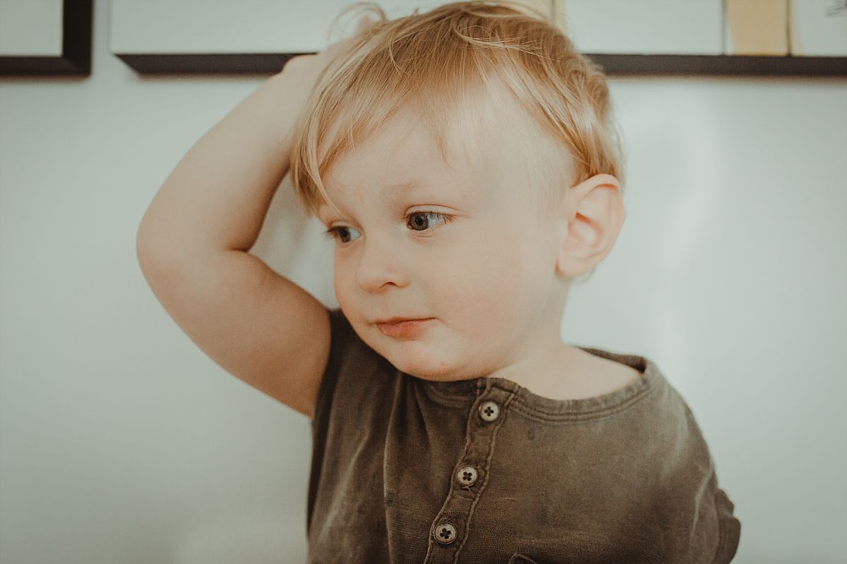 nyc family and newborn photographer portrait photo of todder son in parents room in manhattan