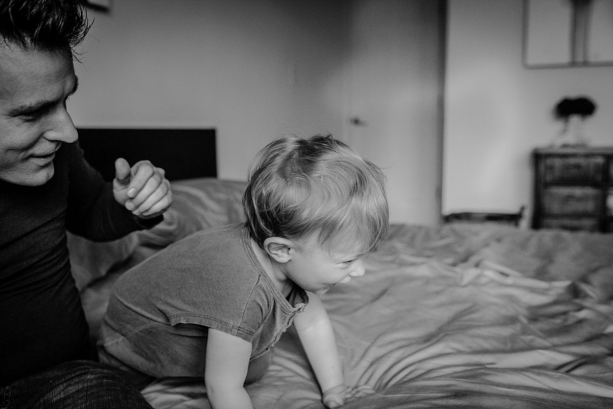 nyc family and newborn photographer dad and son play silly-billies and give big giggles