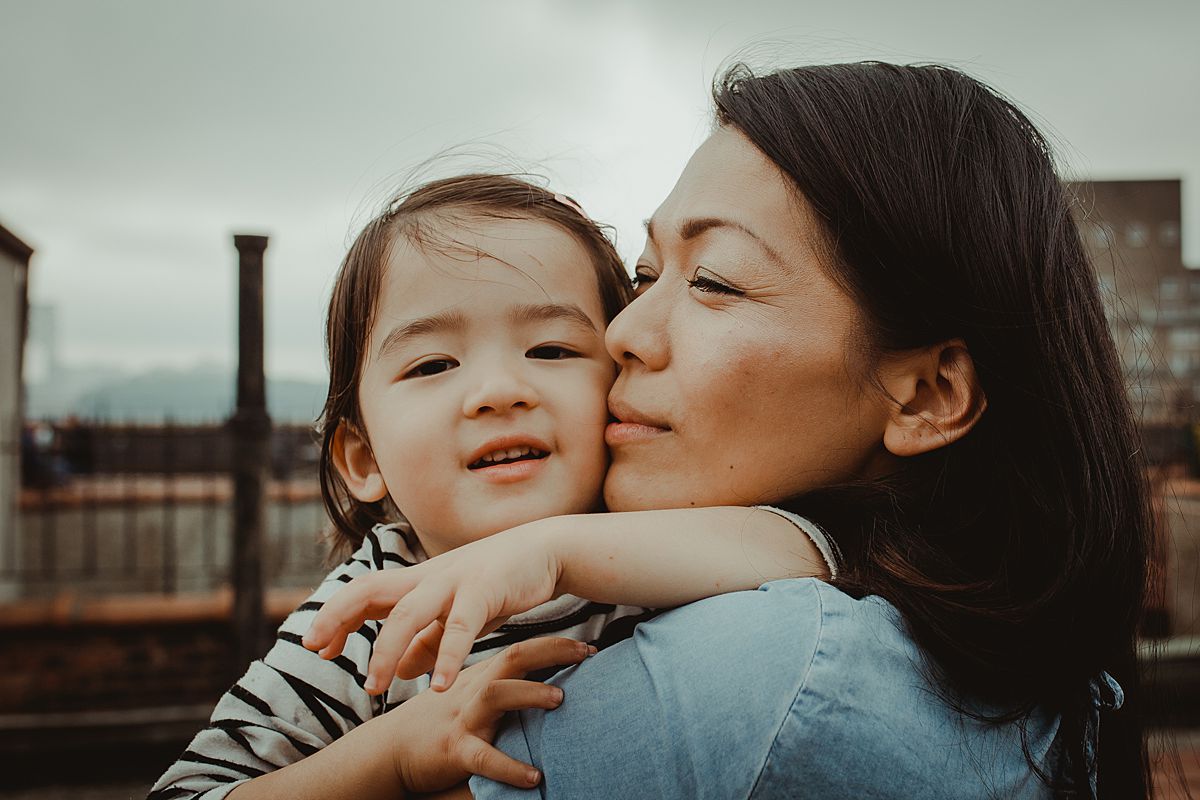 beautiful portrait of mom and her gorgeous Japanese daughter. photo taken on sunny afternoon during documentary family lifestyle session using natural light