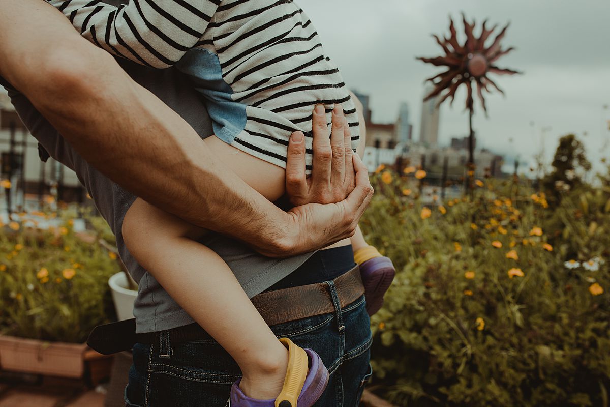 details shot of dad's strong arms holding daughter in piggy back ride. nyc family photographer krystil mcdowall