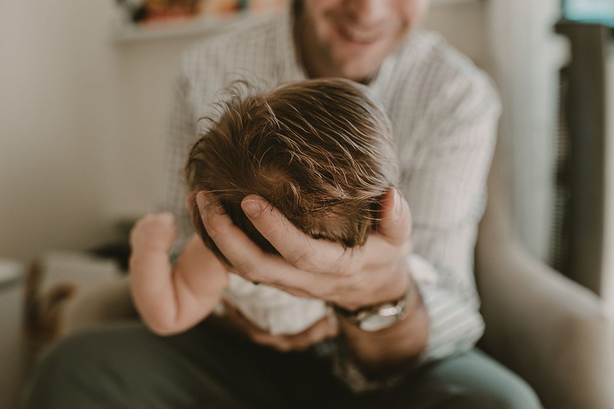 close up of dad holding newborn daughter during nyc newborn session with krystil mcdowall photography