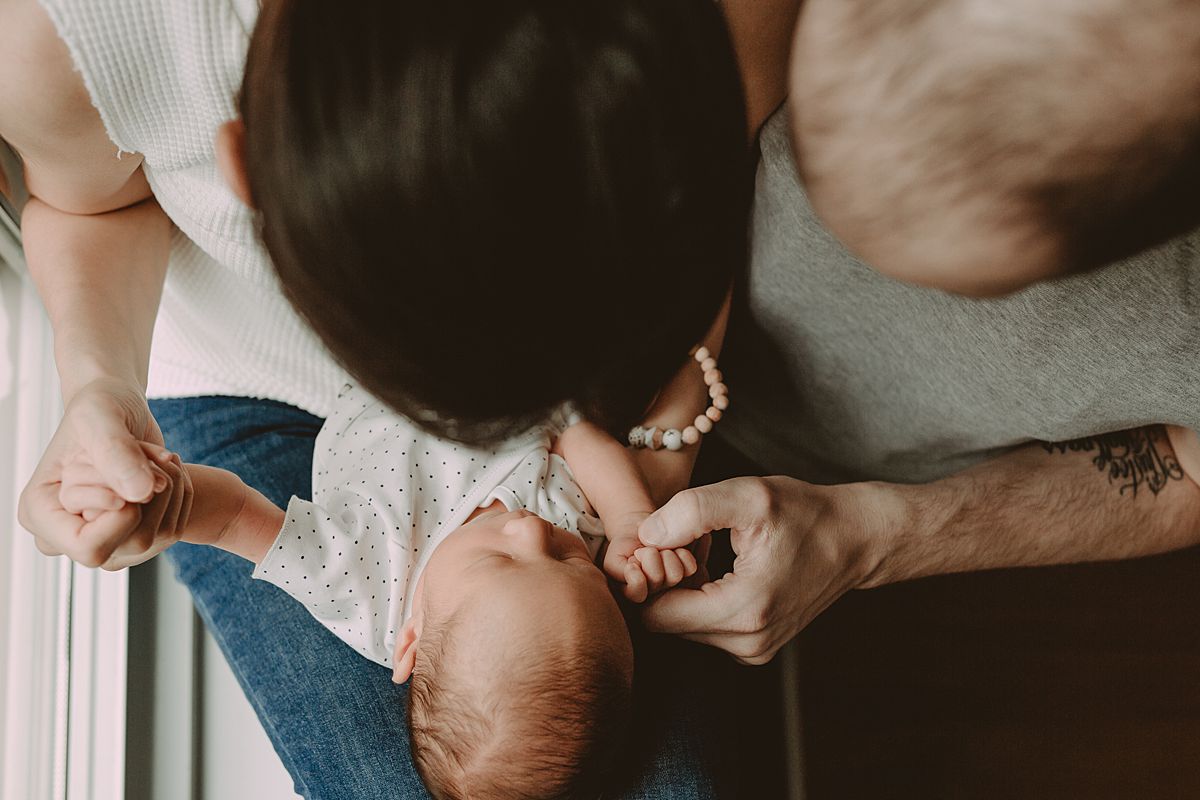 bird's eye view of mom, dad and newborn son laying on mom's lap. image by krystil mcdowall photography