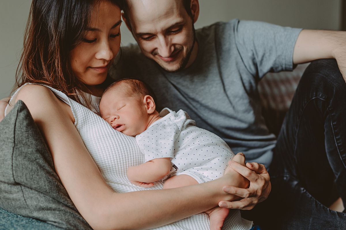 image of family cuddling on couch during nyc family lifestyle session. photo from krystil mcdowall