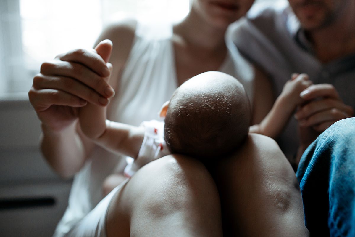 close up of newborn hands playing with mom's hand. photo by nyc family and newborn photographer taken in harlem new york