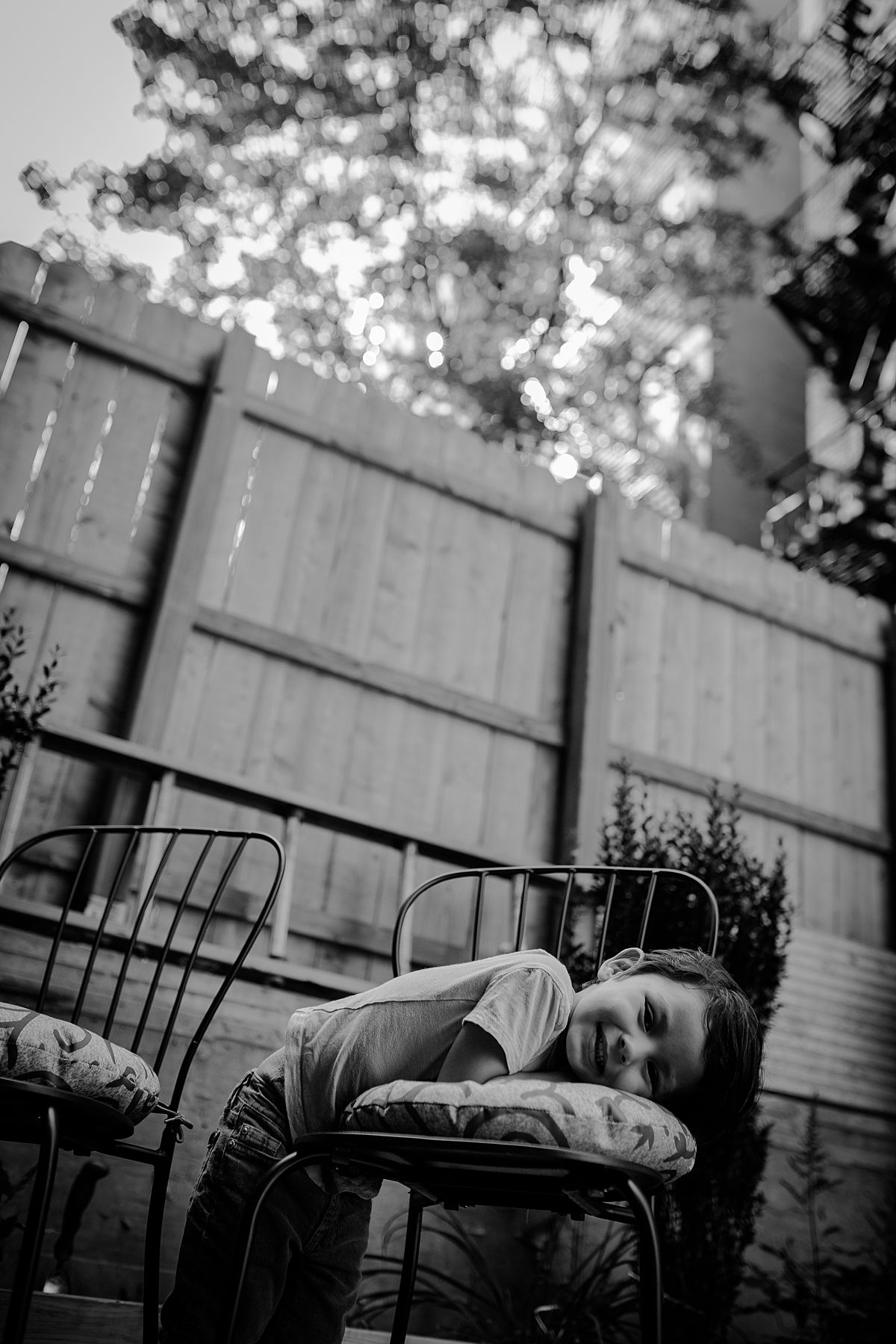 boy leaning on colorful floral chair during documentary family session in new york city
