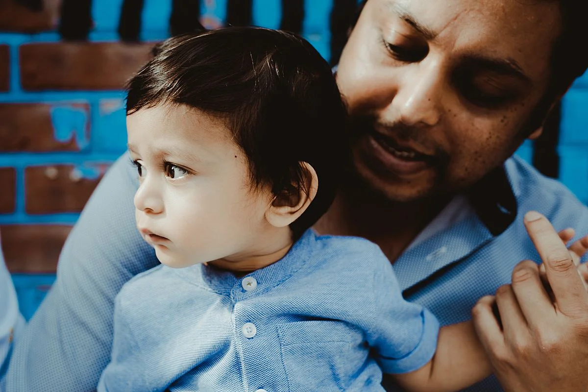 dad holds son. image by nyc family and newborn photographer krystil mcdowall
