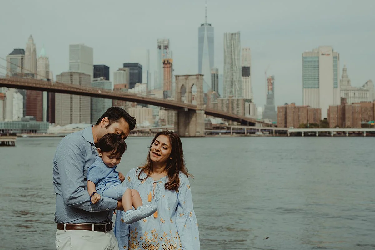 son, mom and dad close up in dumbo brooklyn. photo by nyc family and newborn photographer krystil mcdowall