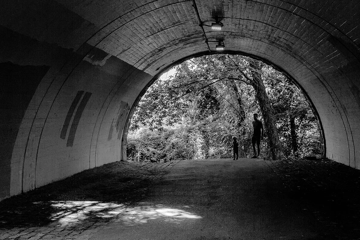 dad and son play in a tunnel in the upper upper upper west side in nyc