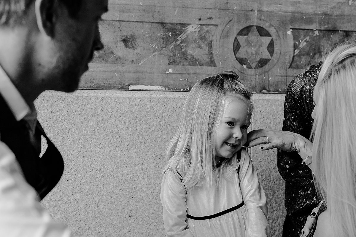 candid photo of mom interacting with daughter as dad looks on lovingly during documentary family photo session with krystil mcdowall photography