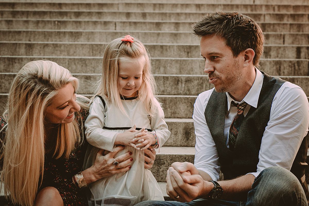 mom, dad and daughter playing on steps at bethesda terrace nyc. image by krystil mcdowall photography