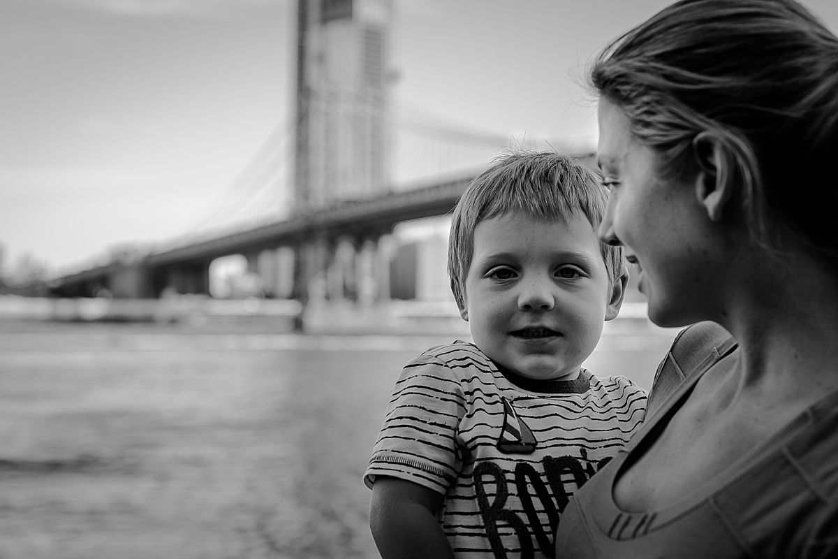 portrait of mon and toddler son standing in front of the manhattan bridge. photo by nyc family photographer krystil mcdowall