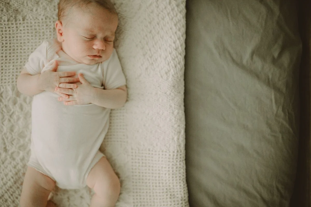 newborn portrait of baby sleeping on specially made blanket in downtown manahttan apartment. image by nyc newborn photographer krystil mcdowall photography