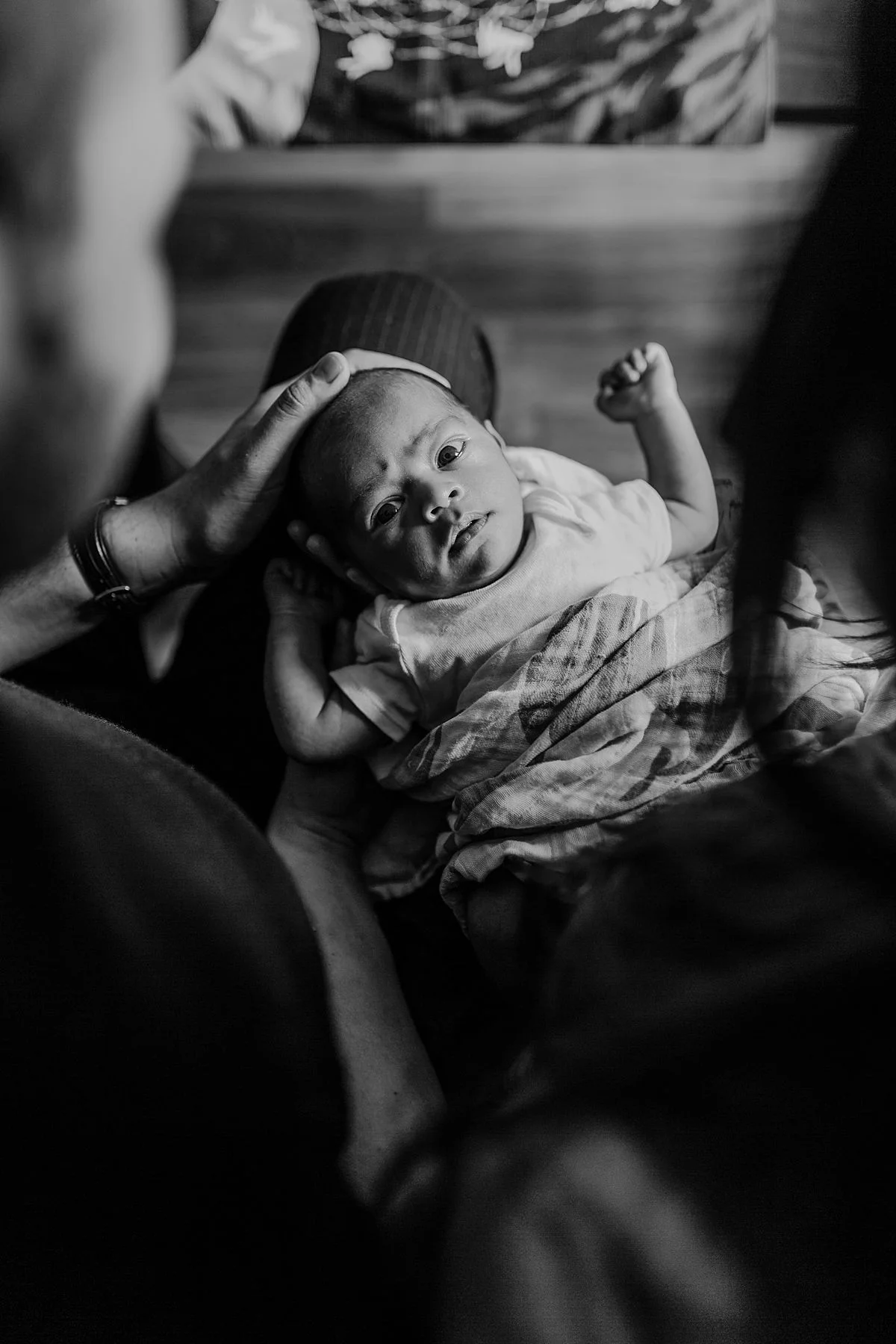 photo of newborn boy taken while standing from behind his mom and dad. photo by nyc family and newborn photographer krystil mcdowall