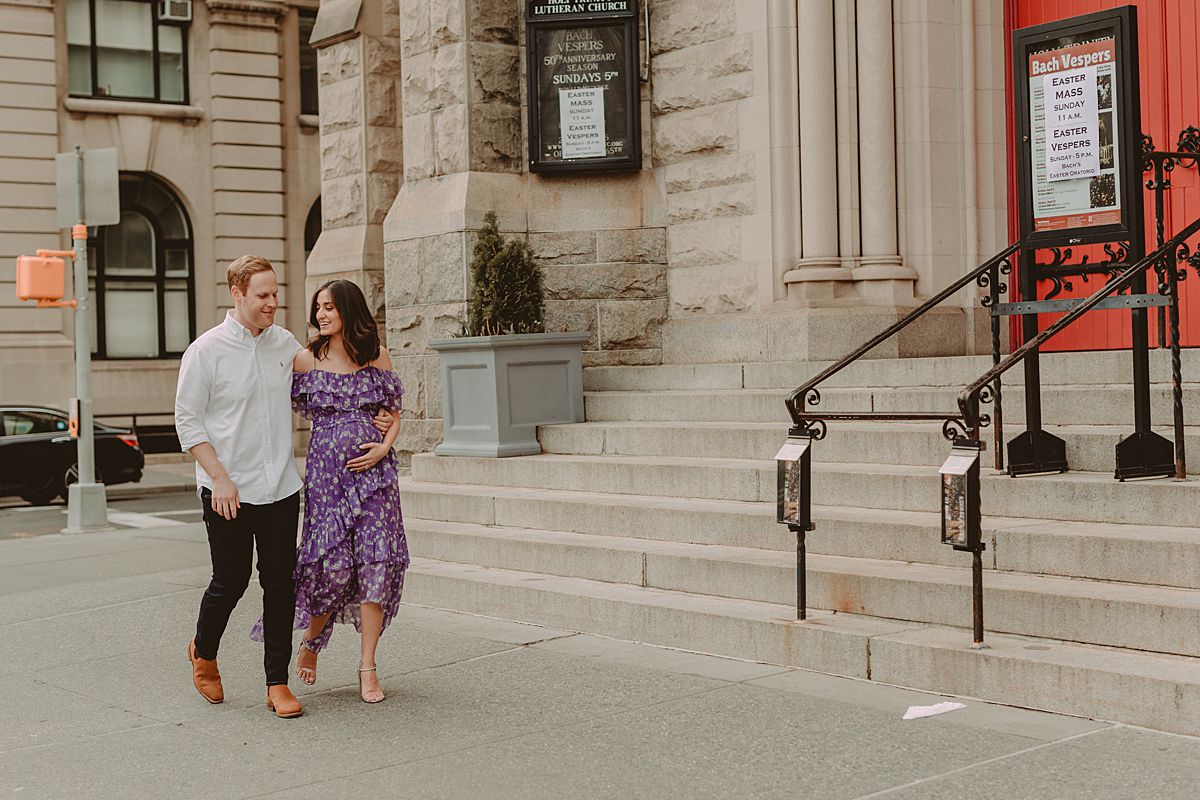 expecting couple walks in front of old church on central park west in new york city. maternity photo by nyc family and newborn photographer krystil mcdowall