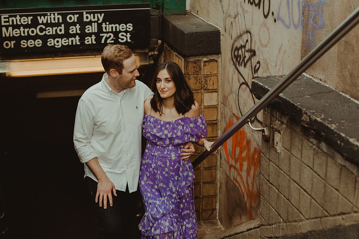 portrait of expecting couple leaving subway station at west 72nd street just off of central park west nyc. maternity photo by nyc family and newborn photographer krystil mcdowall