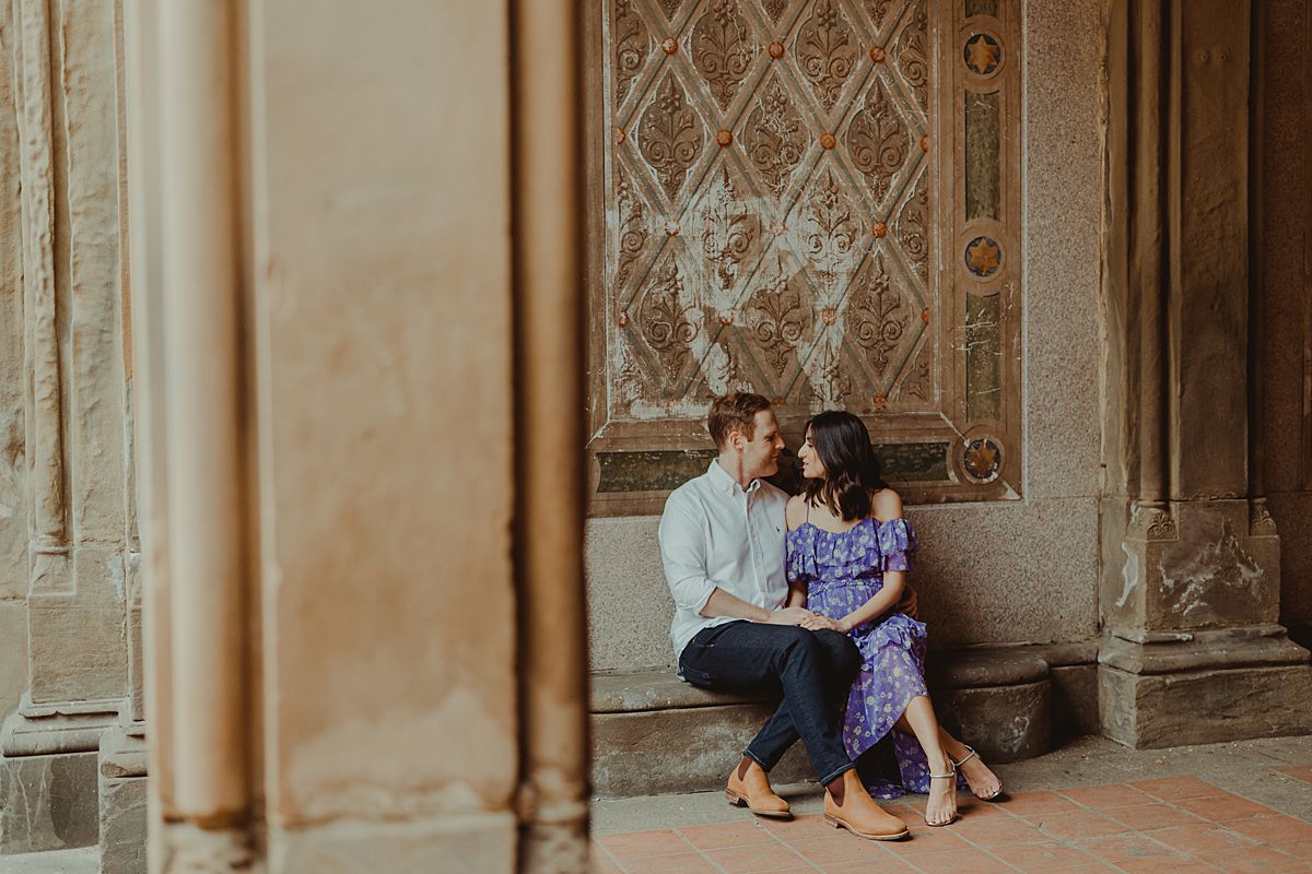 expecting couple sits at bethesda terrace in central park. image by nyc family and newborn photographer krystil mcdowall