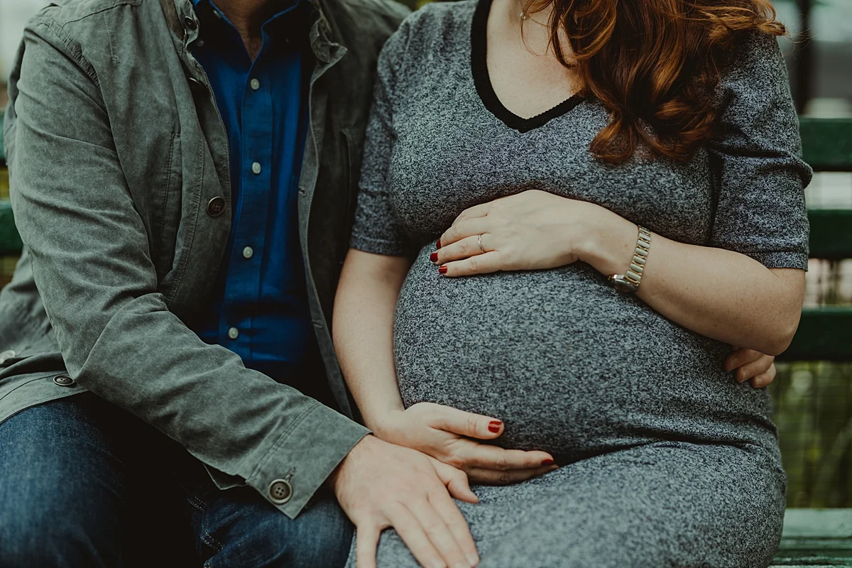 close up photo of expecting dad touching pregnant belly of his expecting wife during maternity photo session in nyc. photo by nyc family and newborn photographer krystil mcdowall