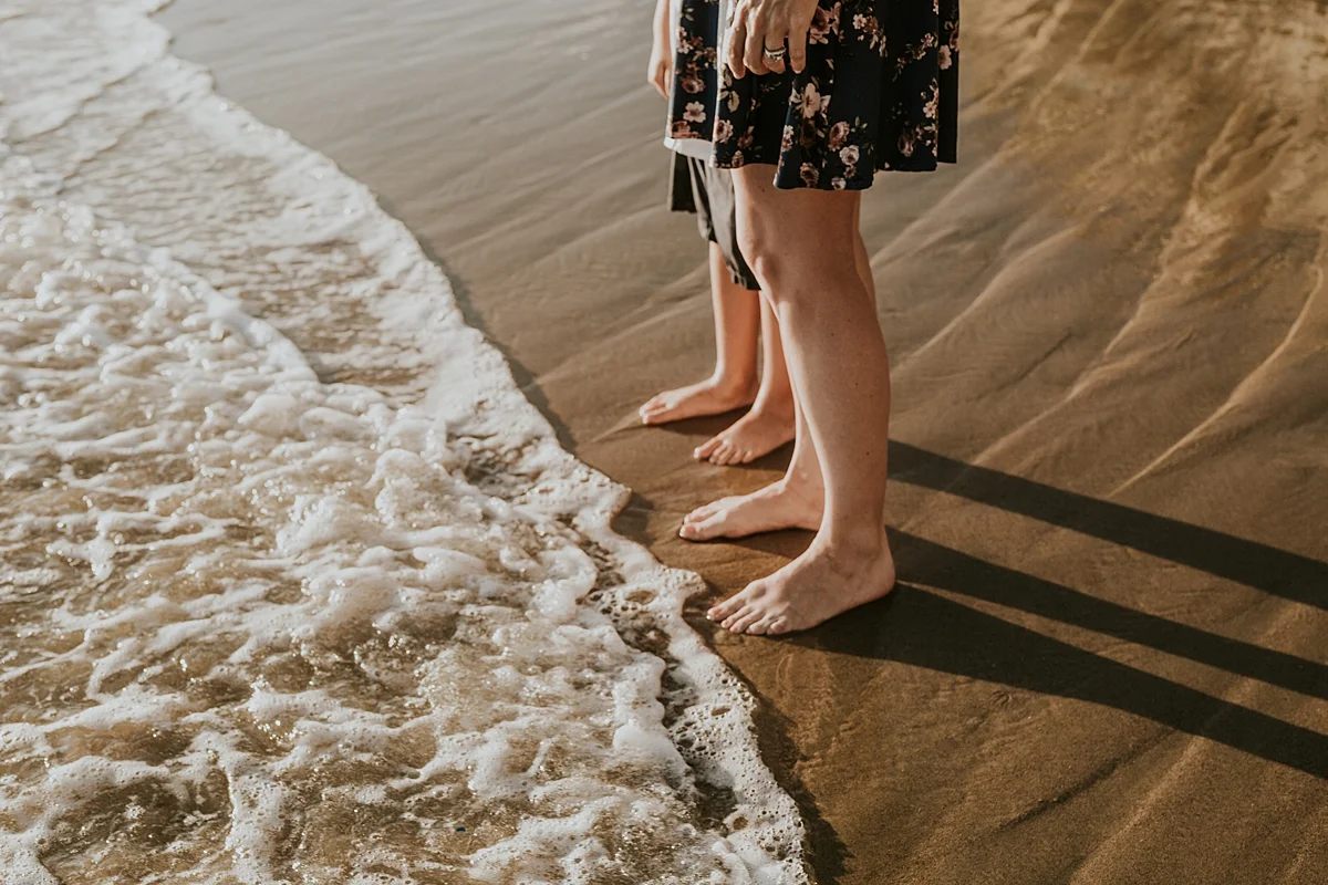 orange county family photographer image of feet before ocean white wash hits them at corona del mar state beach