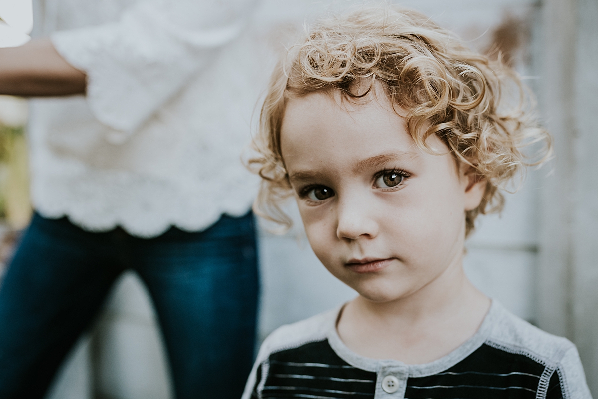 Orange County family photographer. Portrait of young curly blonde haired boy during documentary photo session with Krystil McDowall Photography