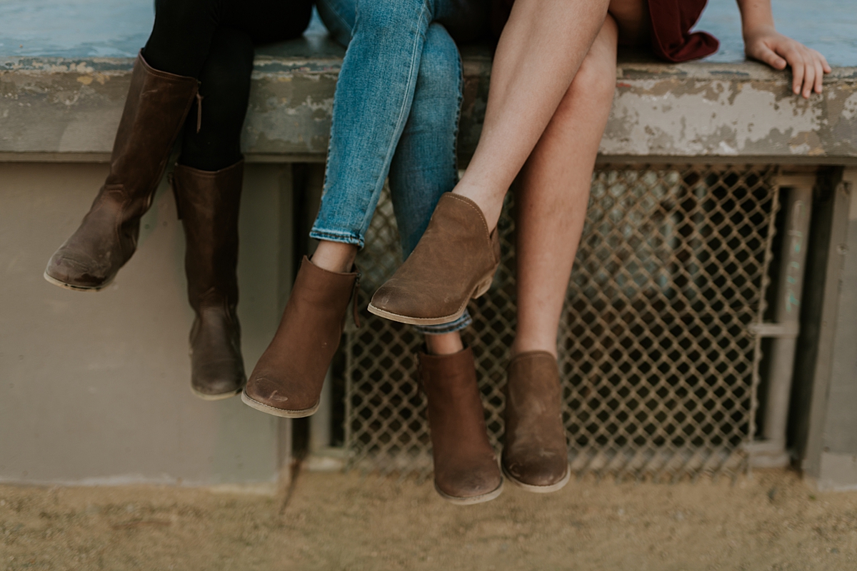 Orange County family photographer. Photo of fall boots worn by mom and her two daughters at a family photo session at Top of the World Laguna Beach