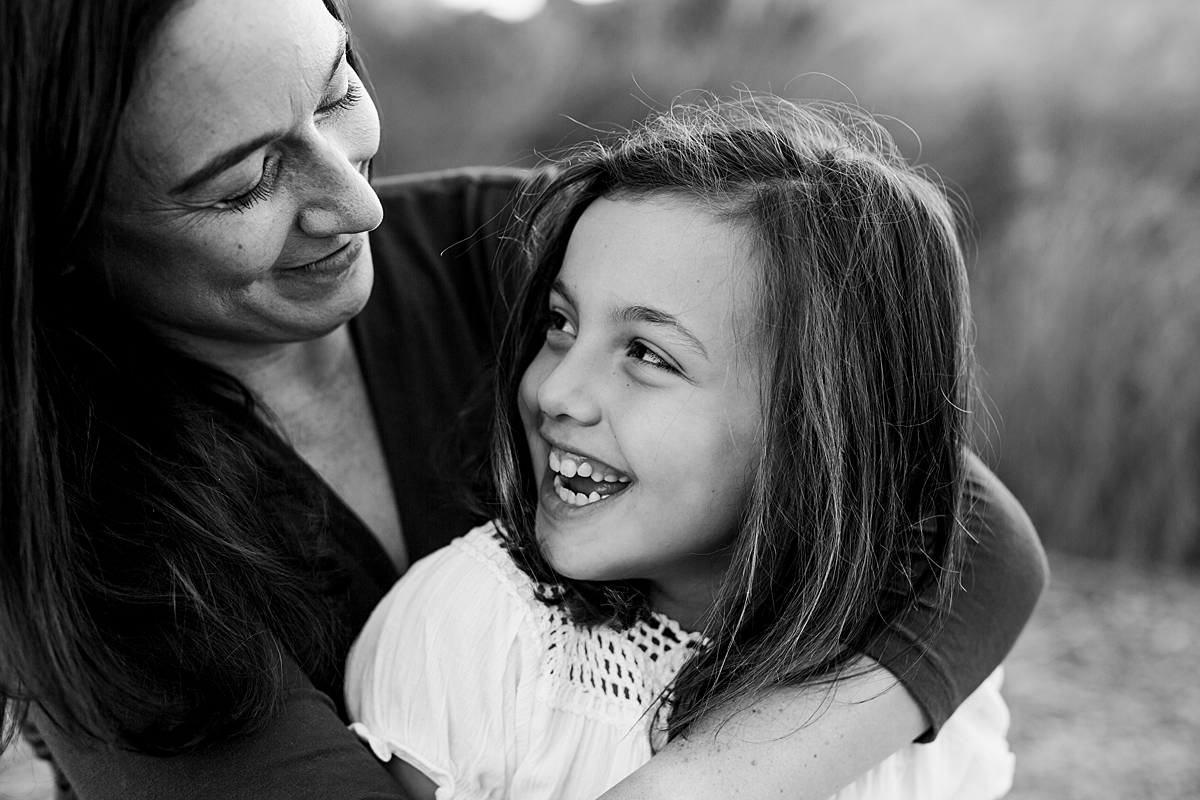 Orange County family photographer. Beautiful black and white portrait of mom and her daughter looking lovingly into each other's eyes during family photo shoot at Quail Hill