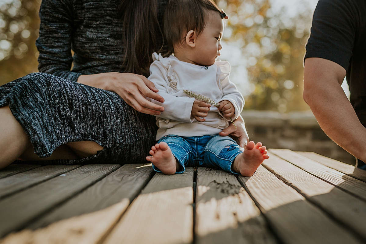 Orange County family photographer. Photo of girl sitting against her mama on a park bench during outdoor family photo session at Jeffrey Open Space Trail Irvine
