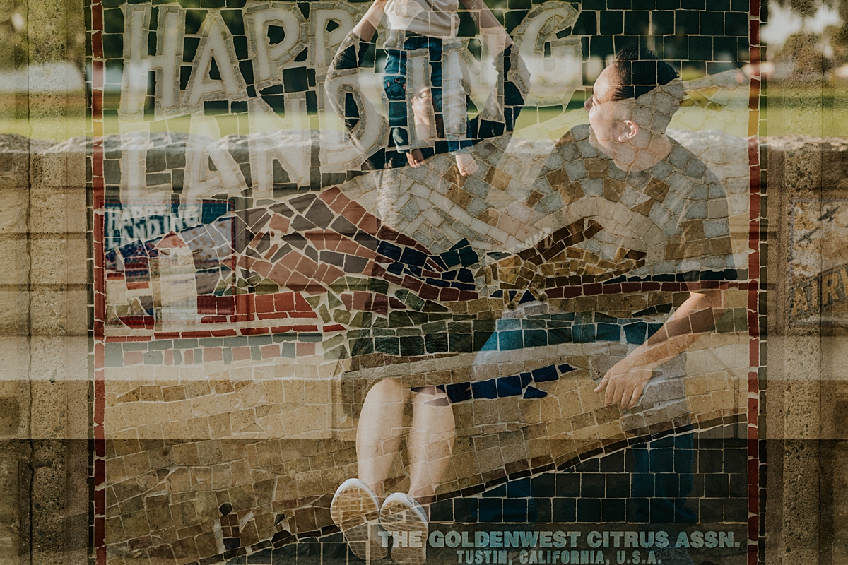 Orange County family photographer. Double exposure of mom holding daughter in the air and tiled orange packing sign on top taken during outdoor family photo session at Jeffrey Open Space Trail Irvine