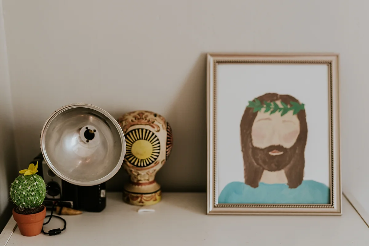 Orange County family photographer. Details photo of cute objects in girl's room including picture of jesus christ taken during in home family photo session in Long Beach, CA