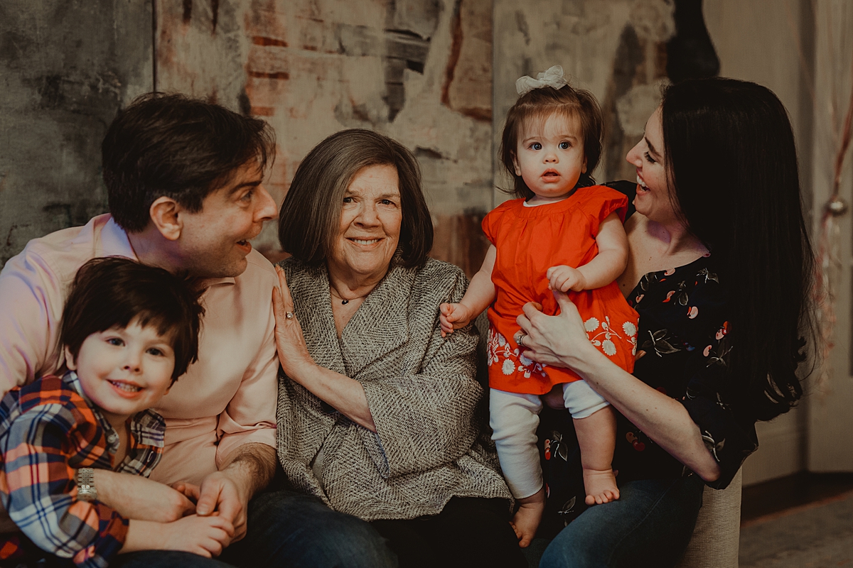 Orange County family photographer. Photo of family of five on lounge taken during in home family photo session with Krystil McDowall Photography