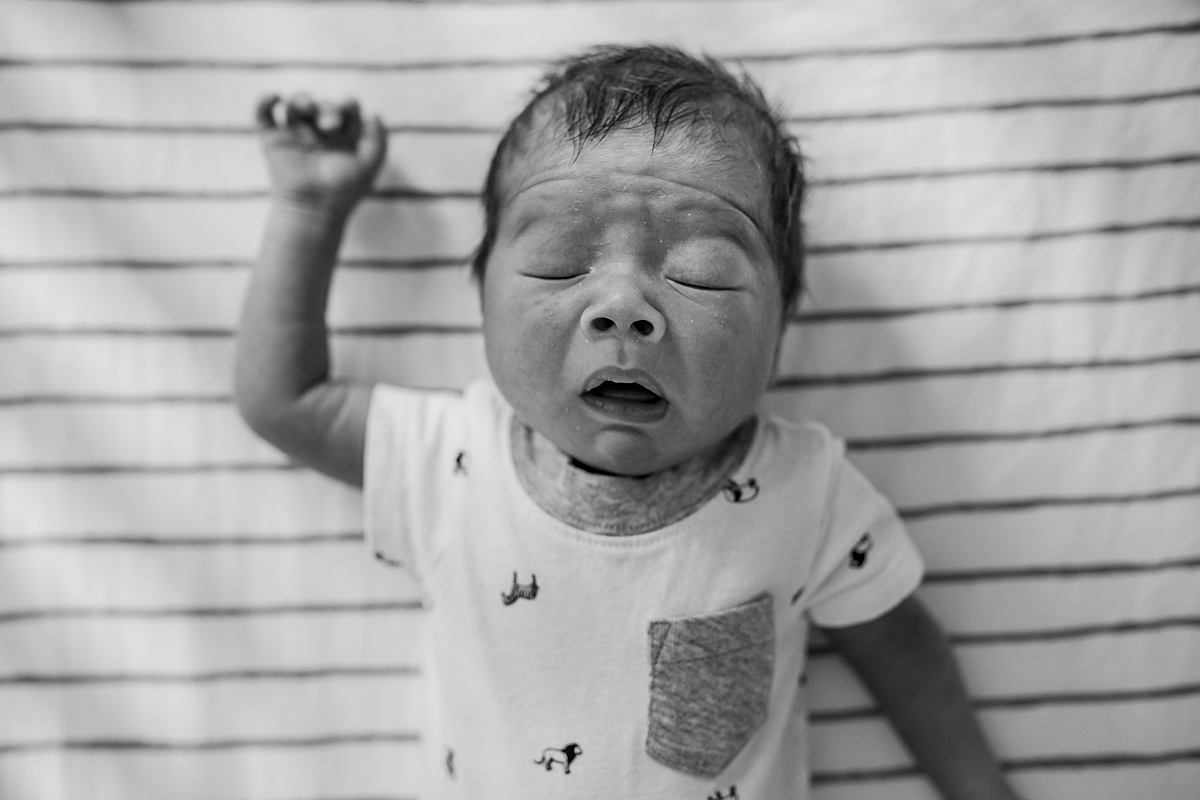Orange County family photographer. photo of newborn baby boy just before he sneezes during newborn photo shoot in Lake Forrest Orange County