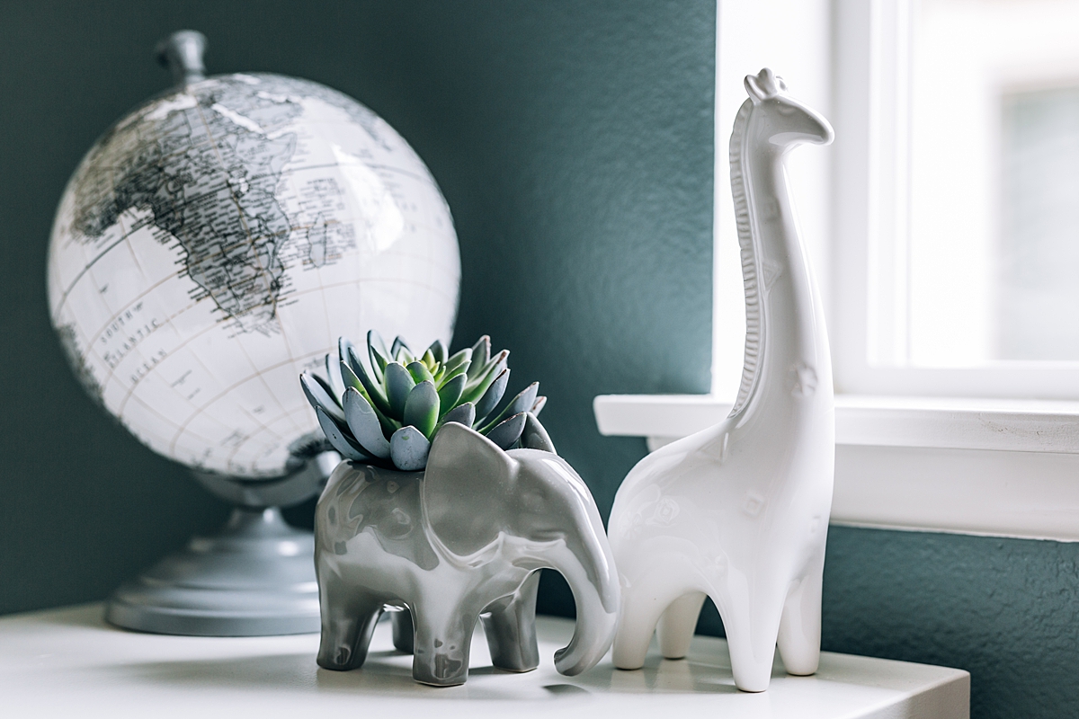 Orange County family photographer. photo of details in newborn nursery including globe, plant and giraffe taken during in home newborn photo shoot in Lake Forrest Orange County