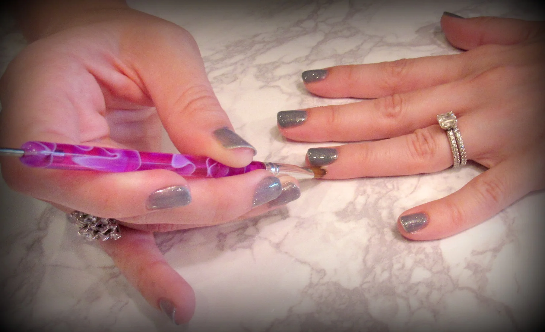 Use a small paintbrush dipped in acetone to clean up excess polish around the nail.