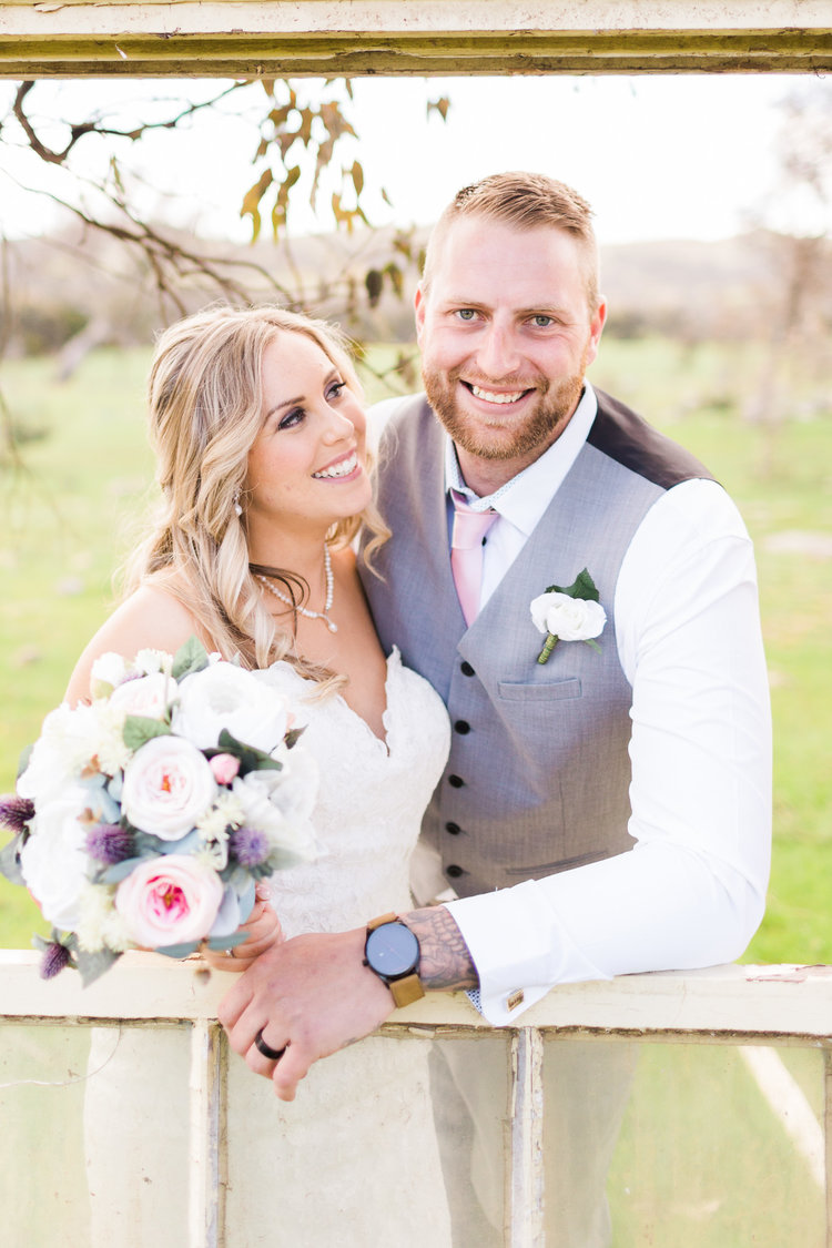 Bride+and+groom+framed+by+old+windows+-+Gold+Creek+Station.jpeg