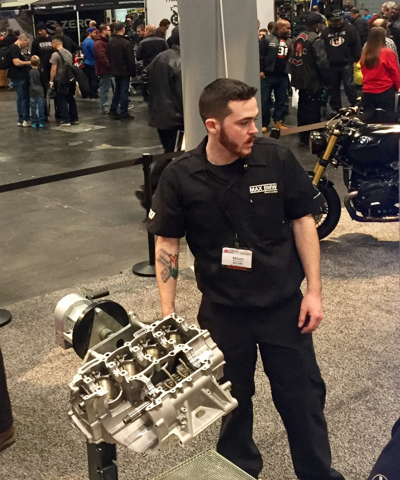 A Max BMW mechanic shows off the inner workings of a BMW engine.