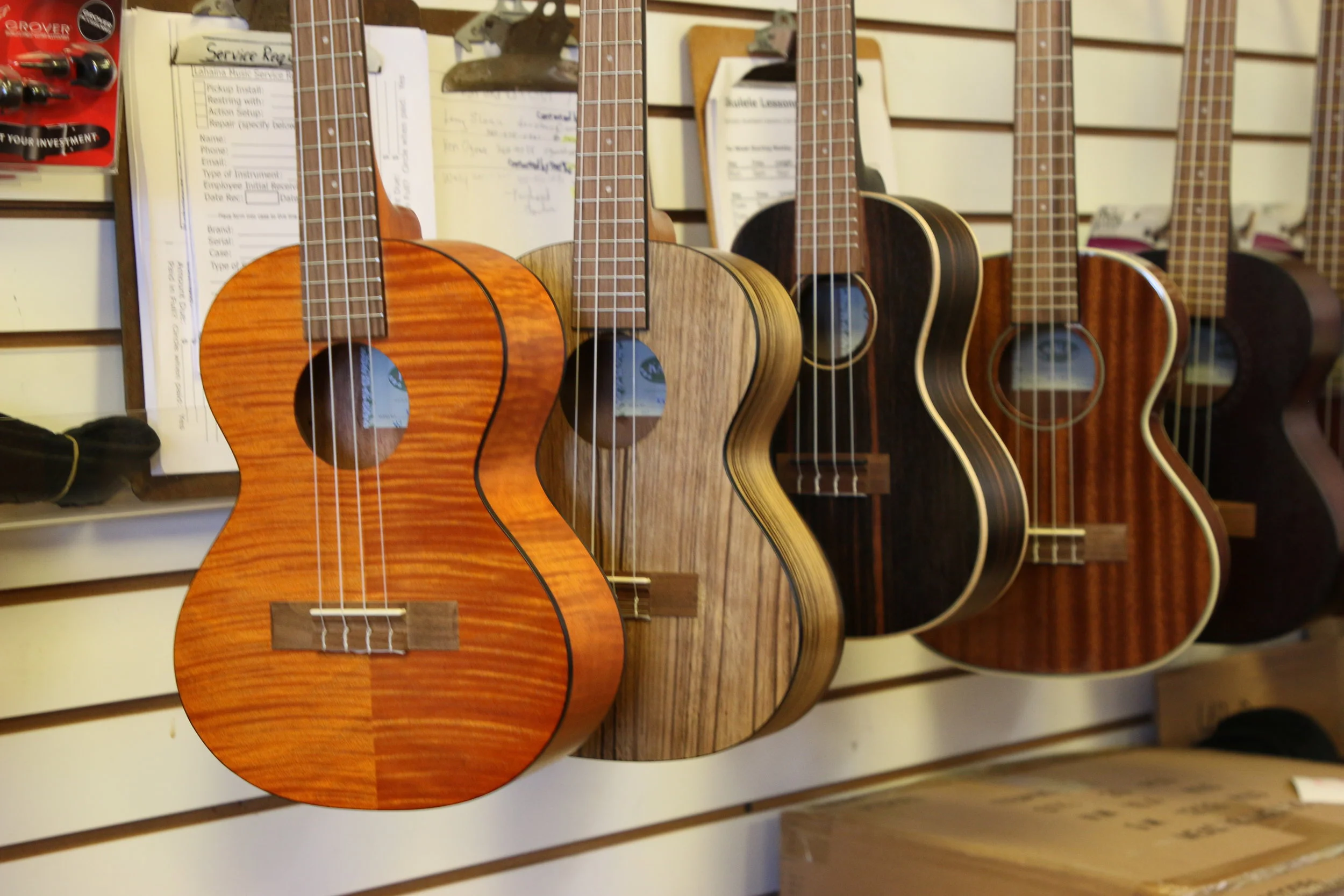 Assorted entry-level Kala ukuleles in Exotic Mahogany, Walnut, and Ebony.