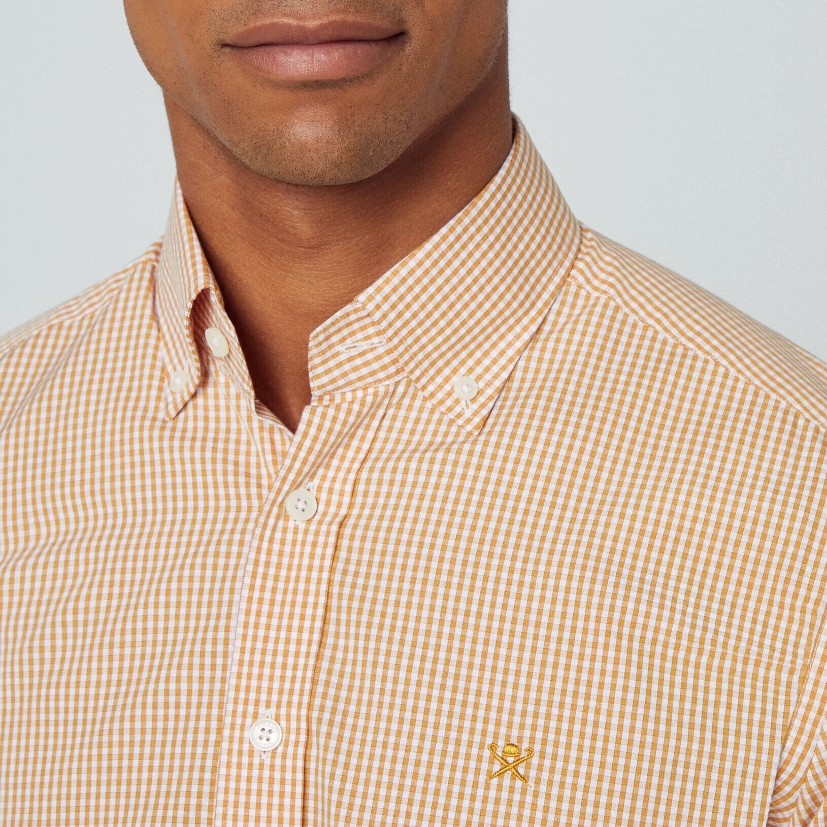 Close view of Model in Hackett Mini Gingham Shirt in Orange