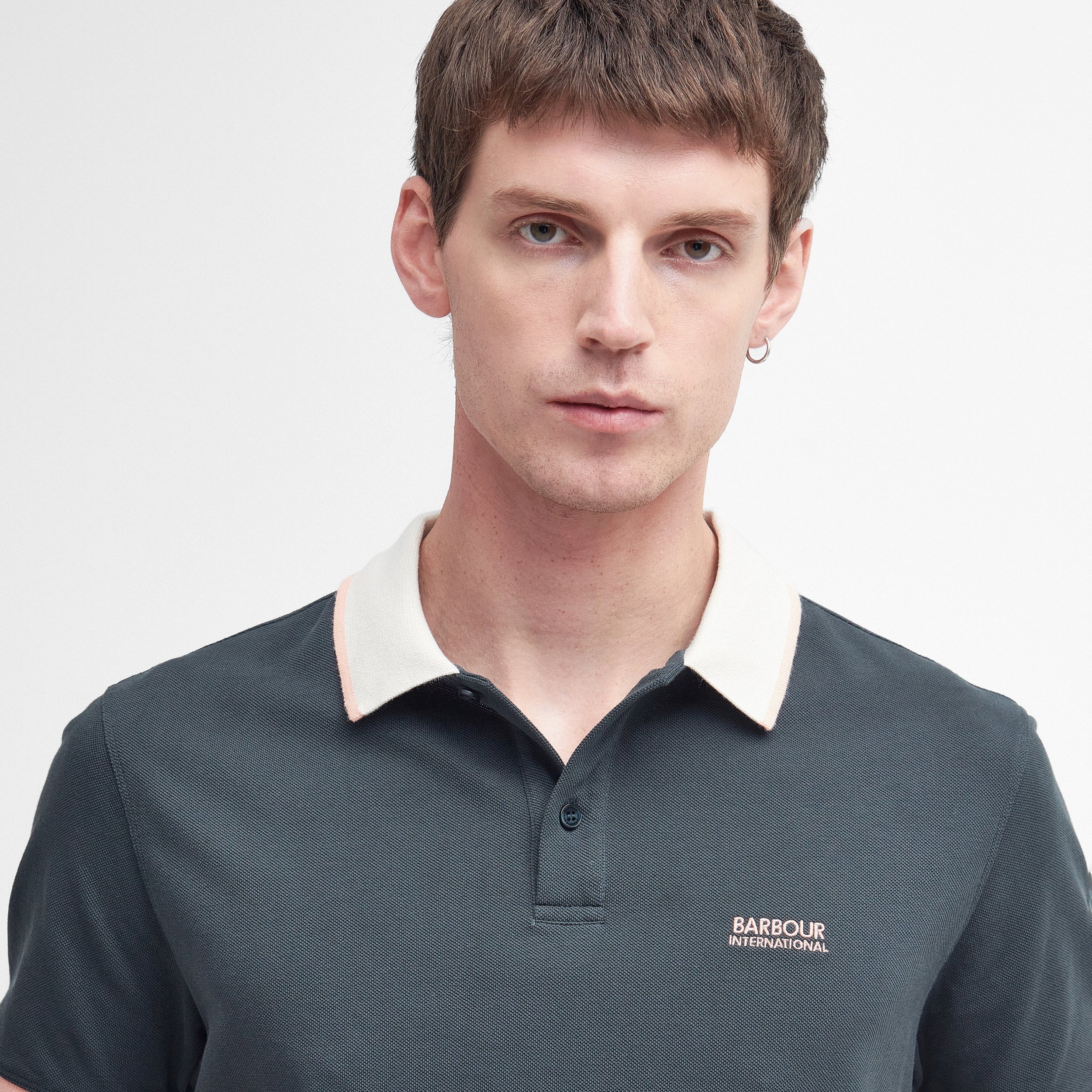 Close View of Model in Barbour International Contrast Collar Polo in Dark Green