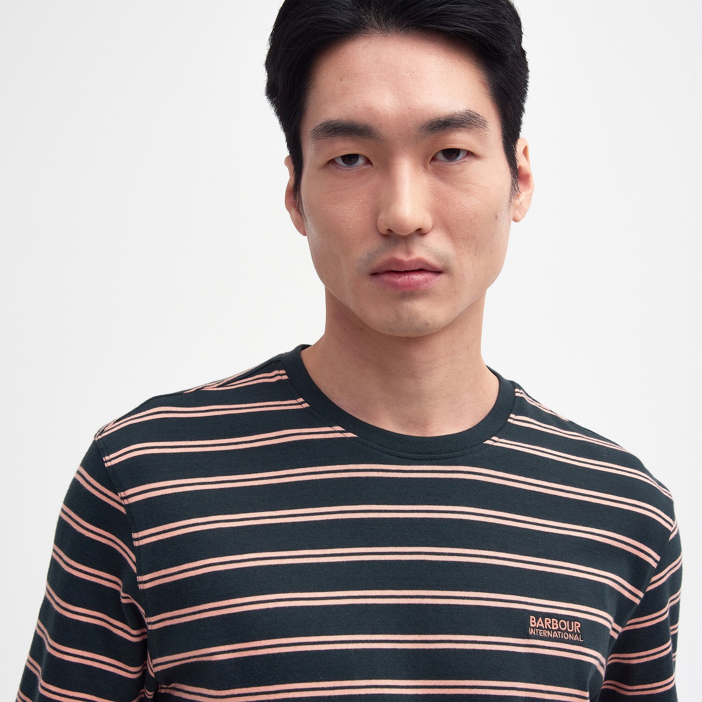 Close View of Model in Barbour International Stripe T Shirt in Dark Green and Peach
